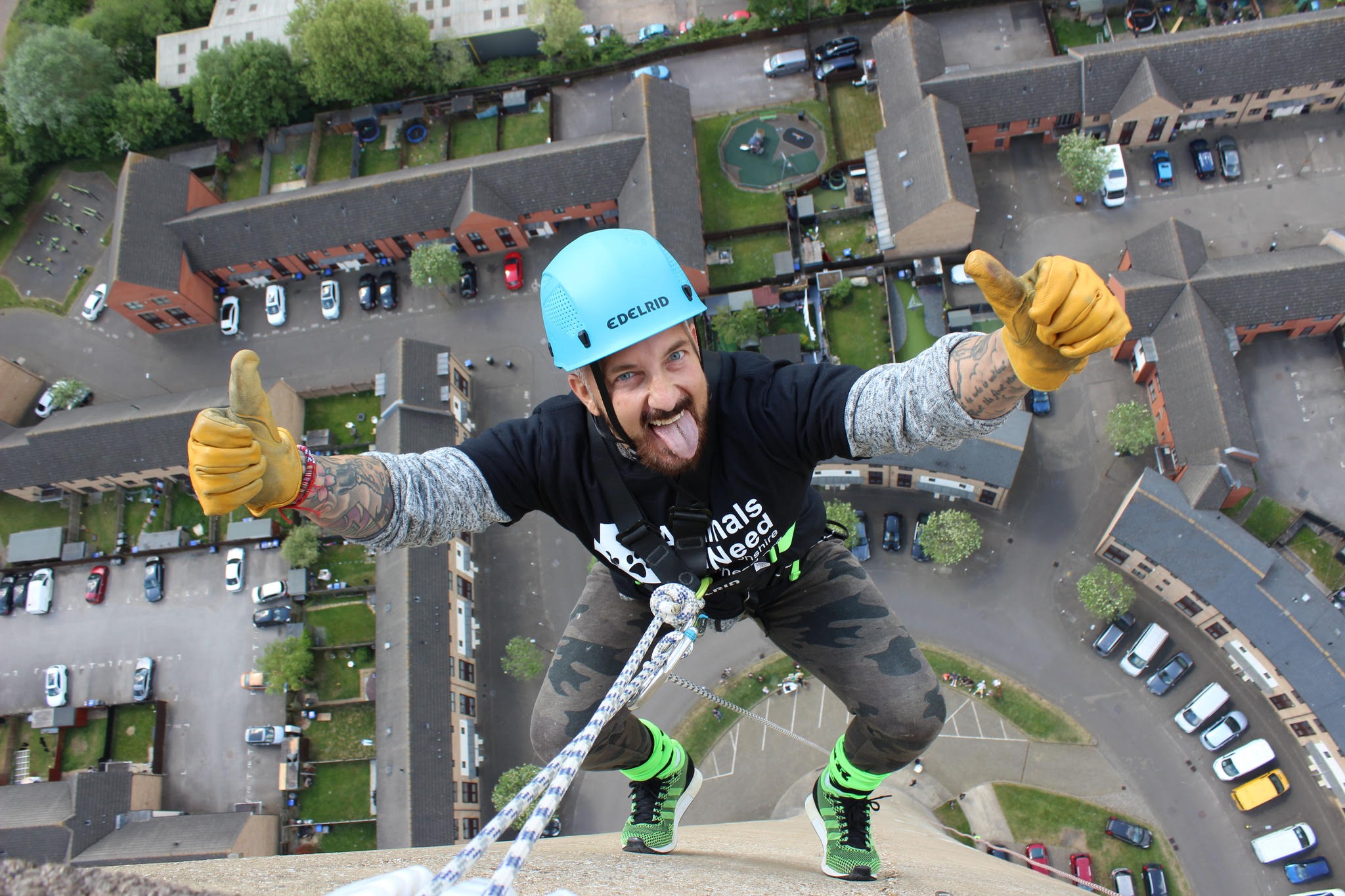 An Animals in Need supporter giving two thumbs up during an abseil above Northampton