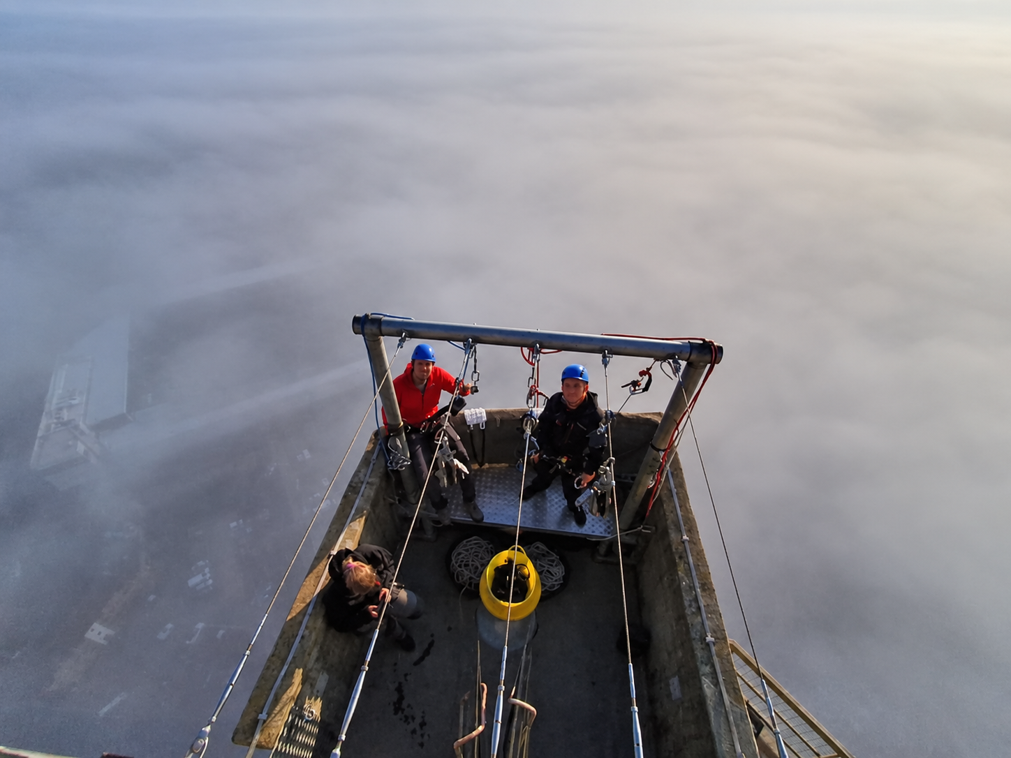 Abseilers on the National Lift Tower platform, high above Northampton in the mist